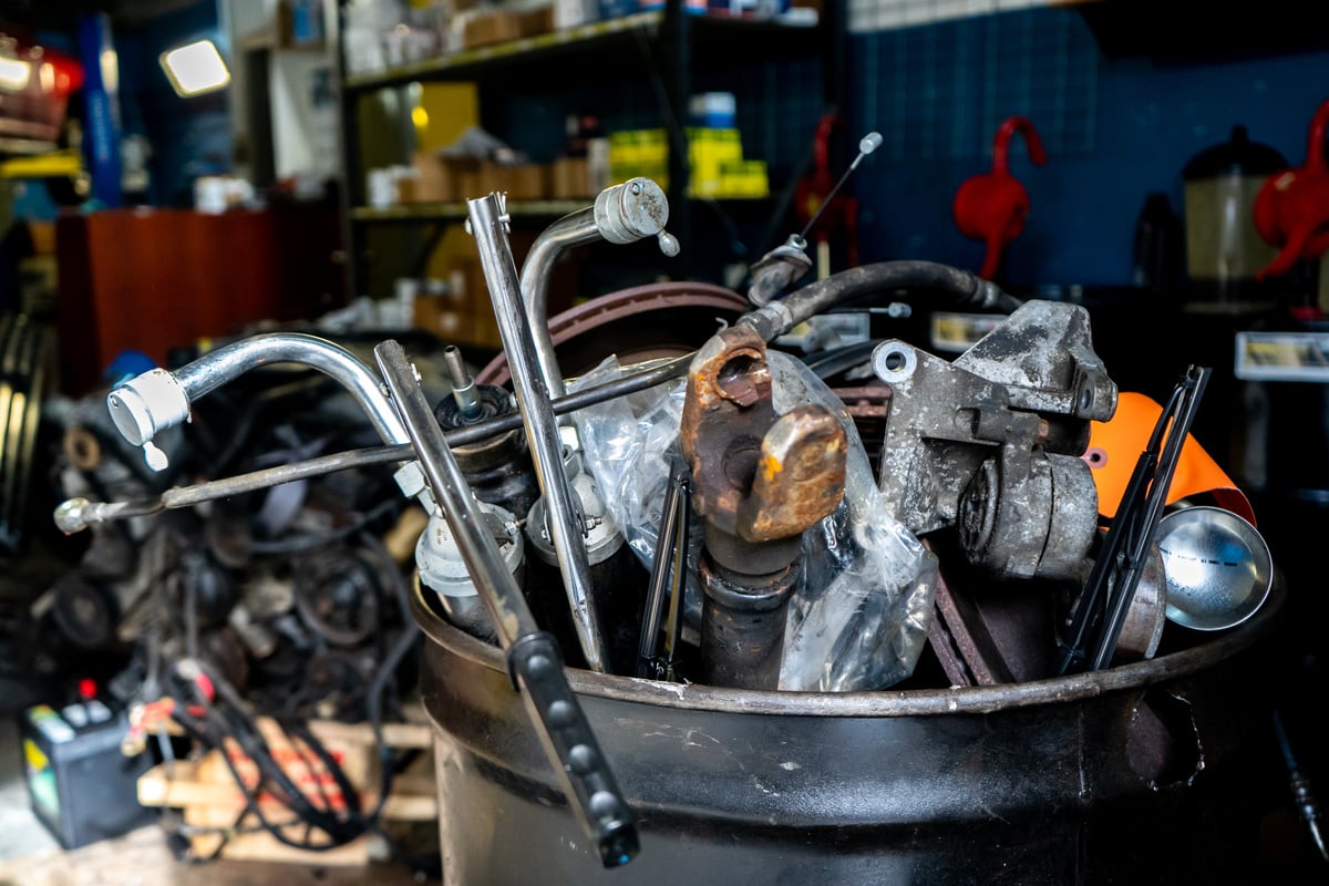 Scrap metal for junk removal in a mechanic automobile repair shop. Car parts for recycling metal.